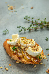 Appetizer bruschetta with pear, honey, walnut and thyme, New Years Eve or Christmas party, vertical image. top view. place for text