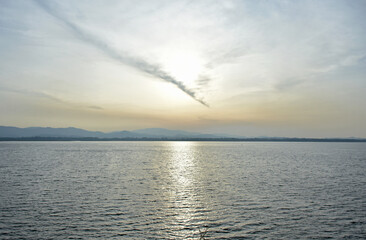 Beautiful cloud line on sky over water surface in evening time.