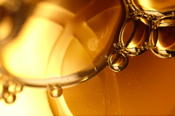 Macro shot of golden liquid bubbles 