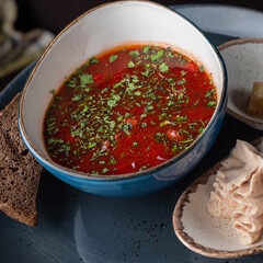 Traditional Ukrainian Russian borscht . Bowl of red beet root soup borsch with white cream .