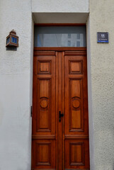 old wooden door in a wall, the old tenement house with wooden door, modern and ancient