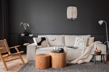 Interior design of living room interior with modular sofa, wooden coffee table, dark wall, rattan...
