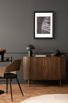 Aesthetic composition of living room interior with mock up posters frame, stylish wooden sideboard, books, gray wall with stucco and personal accessories. Home decor. Template.