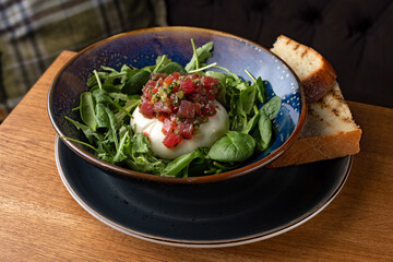 burrata mozzarella cheese with fresh tuna and arugula in sauce
