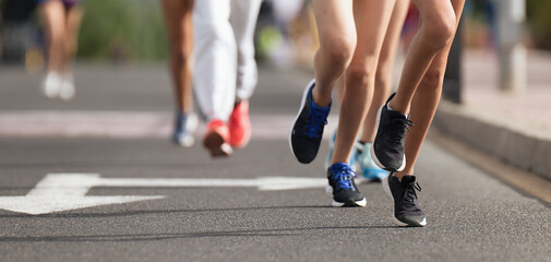 Running children, young athletes run in a kids run race,running on city road detail on legs, running in the light of morning