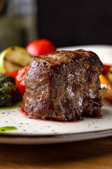 Grilled beef tenderloin steak. Filet mignon with grilled vegetables and pesto sauce