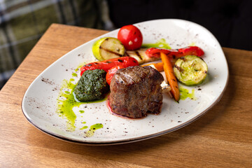 Grilled beef tenderloin steak. Filet mignon with grilled vegetables and pesto sauce