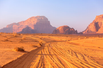 Jordan, Wadi Rum road Jeep safari in desert, off-road car trace on dune sand and beautiful rocks...