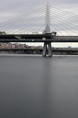 Long exposure. View of Haliç Metro Bridge connecting Azapkapı (Beyoğlu) and Unkapanı (Fatih) (Halic Metro Bridge). blue sky Istanbul Turkey
