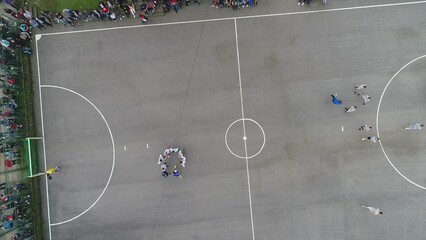 top view drone flying above amateur soccer game match. Countryside authentic tournament. 