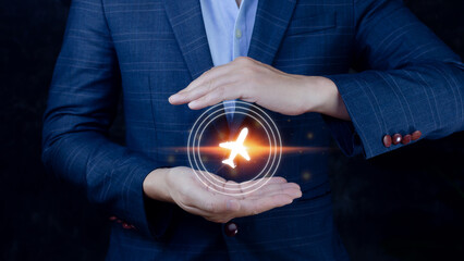 Businessman holding an plane airplane icon in his hands. Online ticket purchase.Travel icons about travel planning, transportation, hotel, flight and passport.Flight ticket booking concept.