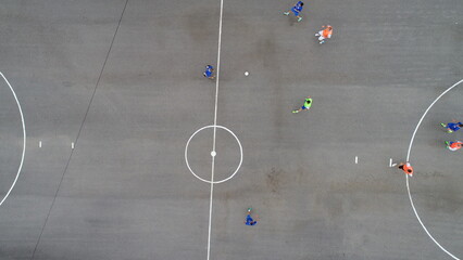 top view drone flying above amateur soccer game match. Countryside authentic tournament.  © .shock