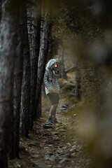 Obraz premium Post Apocalyptic environmental portrait with a gas mask in a dark forest in the evening