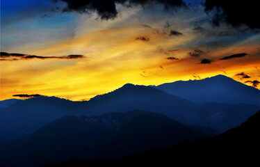 Fiery sunset over the mountains of Carnia, Friuli Venezia Giulia, Italy