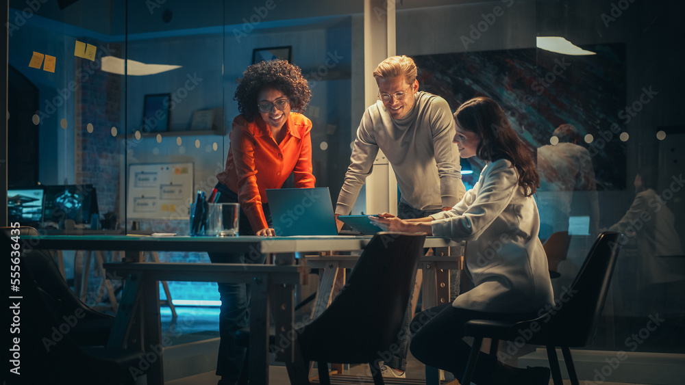Aufkleber diverse team of young managers discussing work at a meeting in office at night. successful business 