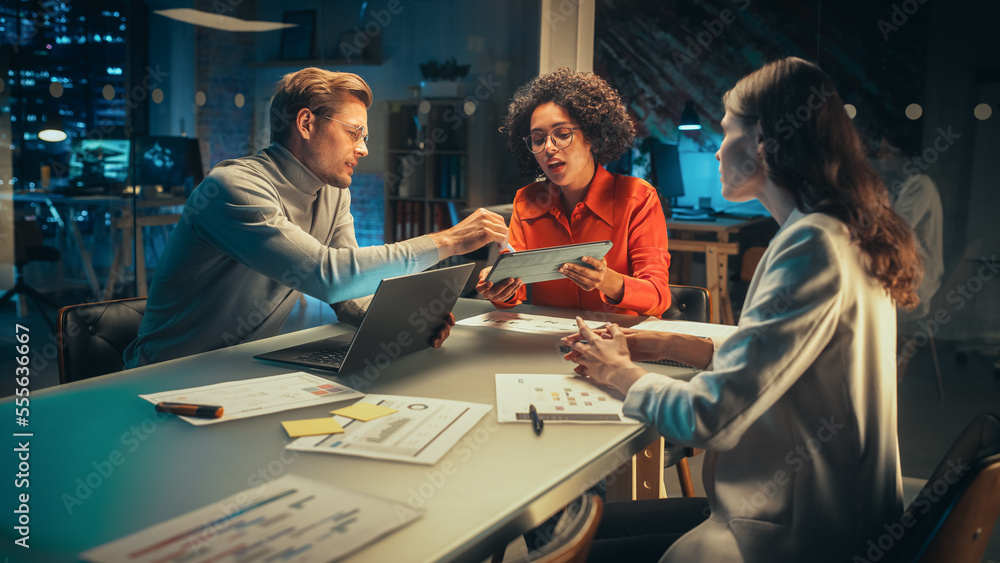 Aufkleber diverse team of young managers discussing work at a meeting in office at night. successful business 