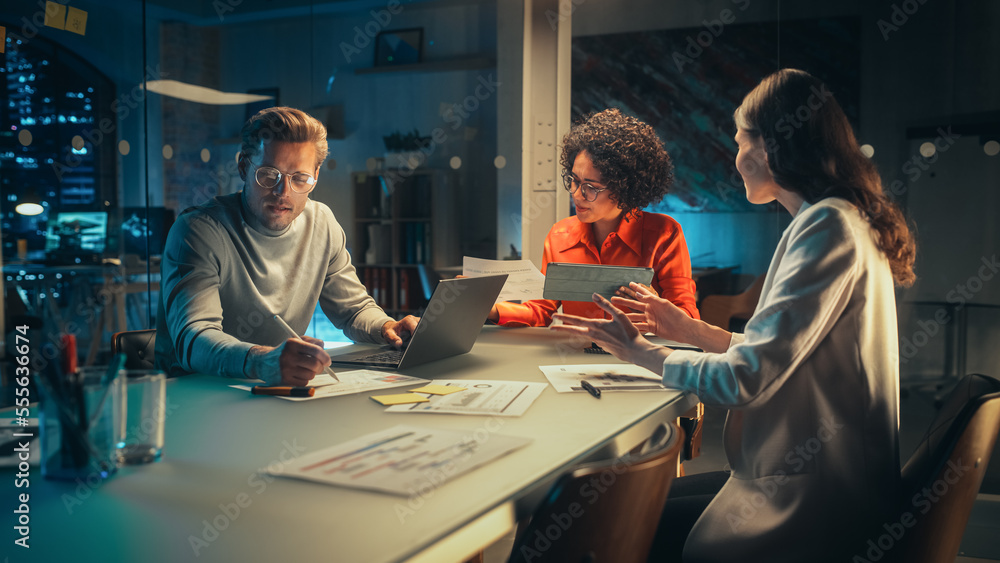 Poster group of managers having a team meeting long after work hours in the evening. colleagues discussing 