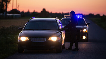 Highway Traffic Patrol Car Pulls over Vehicle on the Road. Female Police Officer Approaches Driver...