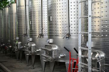Winery producing wine. Wine fermentation tanks.