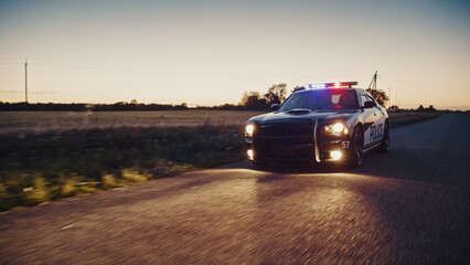 Highway Traffic Patrol Car In Pursuit of Criminal Vehicle. Police Officers in Squad Car Chase Suspect on Industrial Area Road. Criminal Crashes Boxes. Cinematic Atmospheric High Speed Action Scene © Gorodenkoff