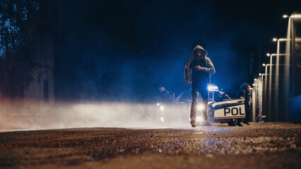 Violent Criminal Resisting Arrest, Trying to Pull a gun on Two Police Officers But Heroic Officer of the Law Disarms, Tackles and Handcuffs Known Felon. Fight Crime. Dramatic Cinematic Shot © Gorodenkoff