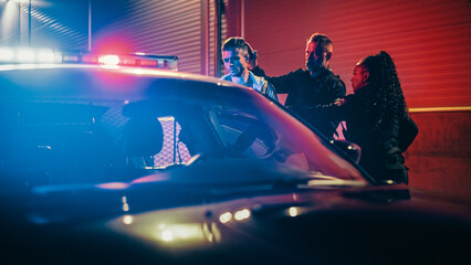 Two Police Officers Arrest Suspect, Put Him in Patrol Сar. Officers of the Law Handcuff Dangerous...