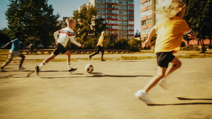 Multiethnic Diverse Friends Playing Soccer Outside in Urban Backyard. Young Boy Dribbling, Passing Opponents Alone with the Ball and Scoring a Goal. Football Players Celebrate the Win.