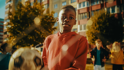 Portrait of a Young Handsome Black Boy Holding a Soccer Ball while Looking at Camera and Smiling....