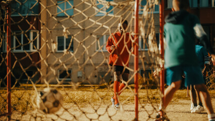 Fototapeta na wymiar Multiethnic Diverse Friends Playing Soccer Outside in Urban Backyard. Young African American Boy Dribbling, Passing Opponents Alone with the Ball and Scoring a Goal.