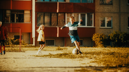 Young Talented Soccer Player Dribbling and Scoring a Goal in a Local Neighborhood Football Match...