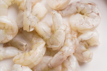Close up of raw greyish shrimp on white background - ingredient for thai coconut soup