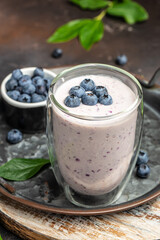 blueberry smoothie in glass, Homemade berry smoothie. Healthy eating. Diet food yogurt on a dark background, place for text, top view