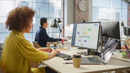 Portrait of a Young Creative Biracial Woman Working on a Computer in Modern Office. Female Chief...