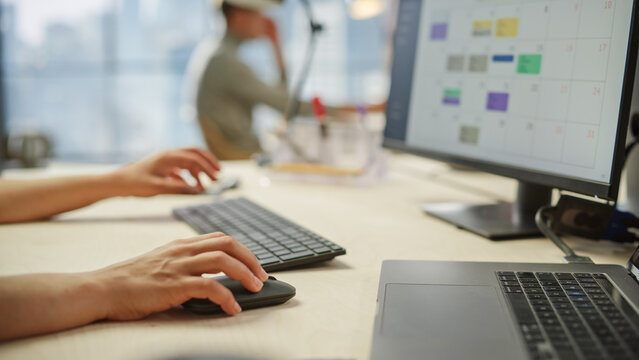 Close Up of a Woman's Hands Working on Keyboard and Monitor. Young Woman's hands Moving the Computer Mouse and Typing. Female Sales Manager Developing a Time Management Plan