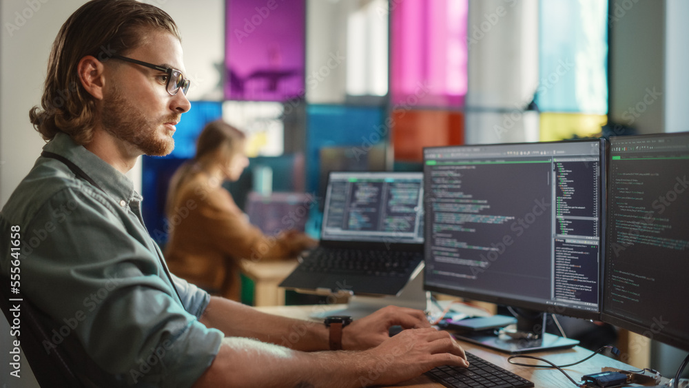 Aufkleber Caucasian Male Software Engineer Coding on Desktop Computer With Multiple Displays in Creative Office. Young Handsome Man Writing Code For Mobile Application In Tech Start-Up Company.