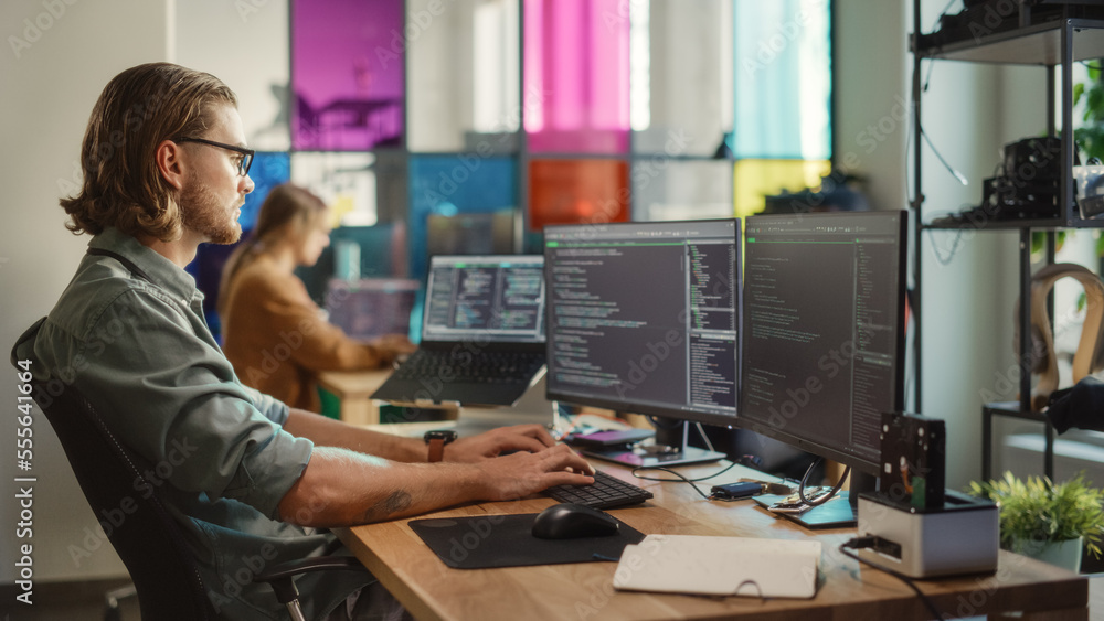 Aufkleber Professional Male Developer Writing Code On Desktop Computer With Two Displays and a Laptop in Creative Office. Caucasian Man Programming Artificial Intelligence Software For Big Tech Company.