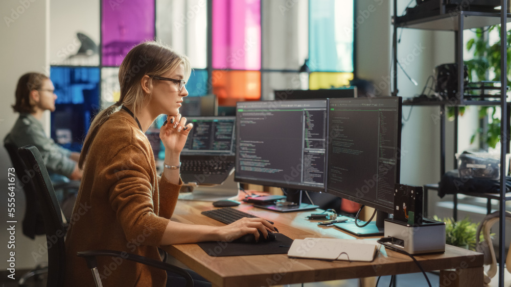 Poster Caucasian Woman Writes Lines of Code on Desktop PC with Multiple Displays and a Laptop in Stylish Office. Professional Female Data Scientist Using Software To Analyze Information from Internet.