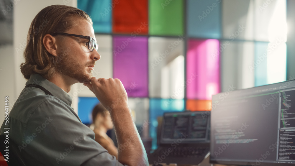 Poster Male Senior Software Engineer Coding on Desktop PC With Multiple Monitors Setup and Laptop Aside in Stylish Office. Caucasian Man Developing Innovative SaaS Platform For Technological Startup Company.