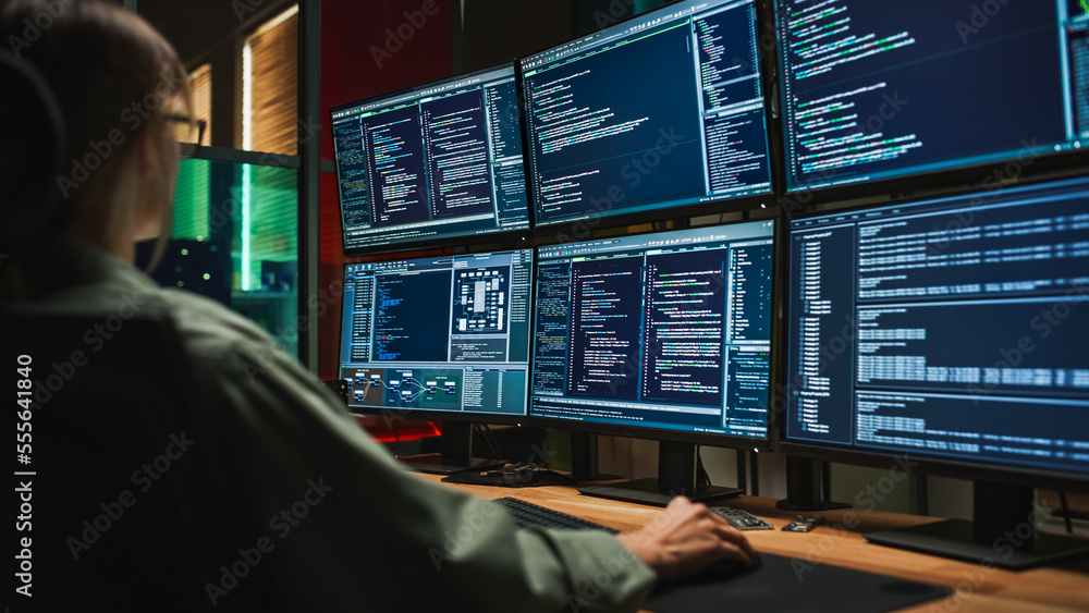 Poster female cyber security student coding on desktop pc with six monitors setup in dark office. caucasian