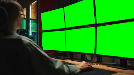 Female Cyber Security Student Coding on Desktop PC With Six Monitors Setup With Green Screen...