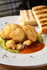 Close up of bowl of guacamole and cauliflower