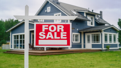 Close Up of a Red House for Sale Sign on a Lawn in Front of a Big Modern House with Traditional Architecture. Housing Market Concept with Residential Property on Sale in the Countryside.
