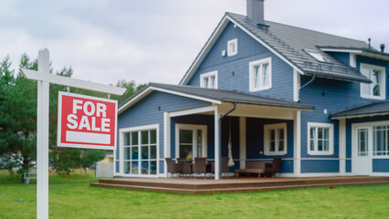 Red Home for Sale Sign in Frontyard of a Big Blue Stylish House with Traditional Architecture....