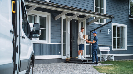 Handsome Young Homeowner Receiving an Awaited Parcel from a Cheerful Courier. Postal Service Worker Comes to the House to Make a Door to Door Delivery and Get a POD Signature on Tablet.