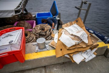 recycling cardboard after a fishing trip on a boat