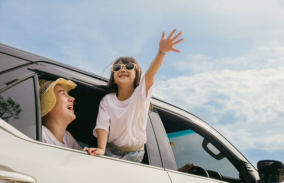Happy family day. Asian mother father and children smiling sitting in compact white car looking out windows, Summer at the beach, Car insurance, Family holiday vacation travel, road trip concept
