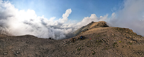panoramic view of the mountain peaks in the clouds. mountain gorge. glaciers, permafrost