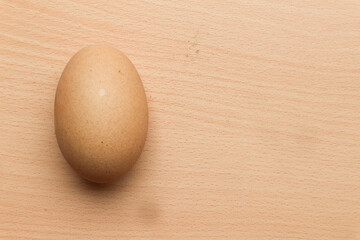 Chicken egg isolated on brown wooden background