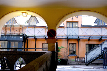 yellow courtyard arches with columns, historical high-rise building of 19th century with beautiful...