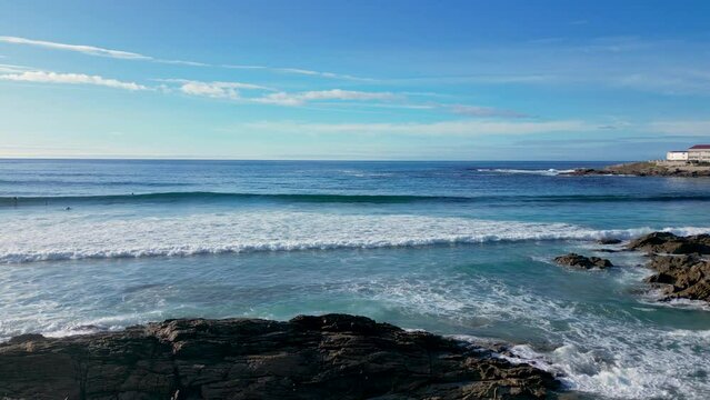 Splashing Waves Onto Coastal Rocks At The Caion Beach In Summer In A Coruna, Spain. wide